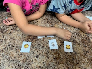 Two children playing the Little Lions Learn Memory game.