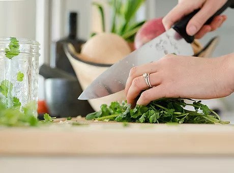 chopping cilantro with a knive