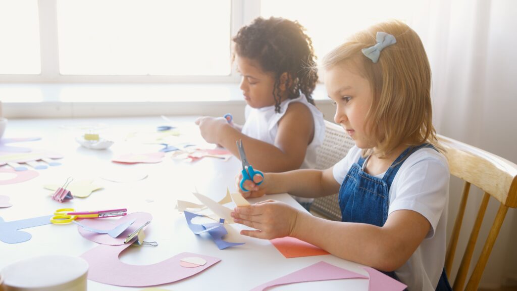 girls cutting paper