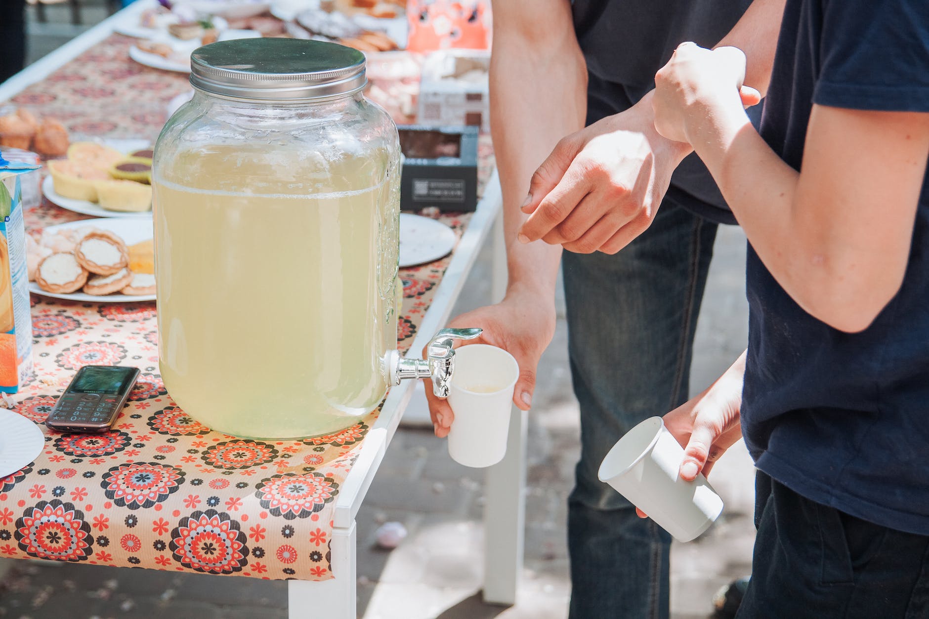 people pouring lemonade