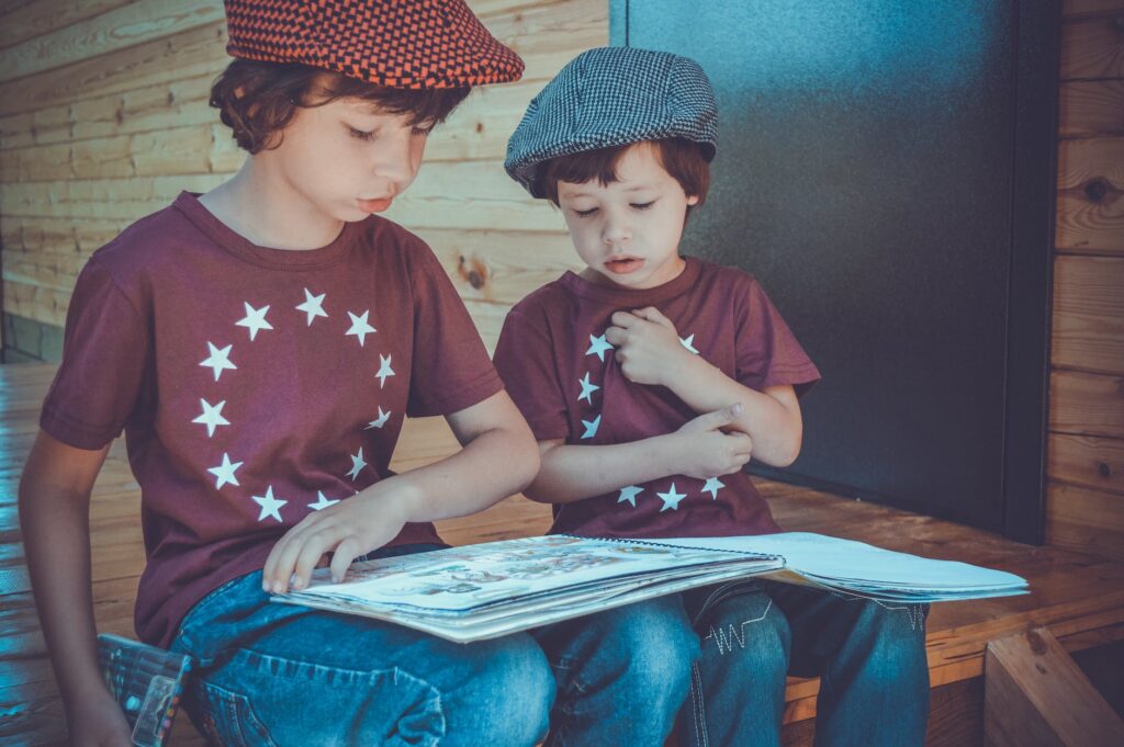 two boys reading a book